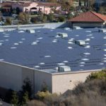 Commercial building roof in shopping center covered with solar p